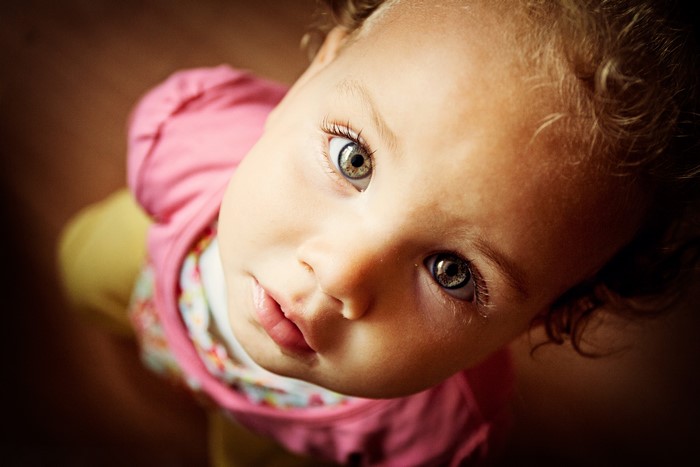 Close-up of a baby girl's face looking up