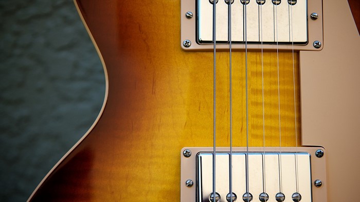 Closeup of an electric guitar with sunburst finish