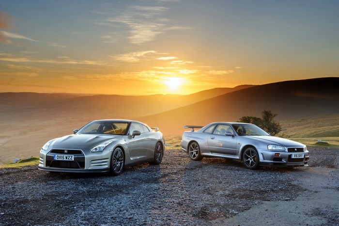 Two Nissan GT-R cars at sunset