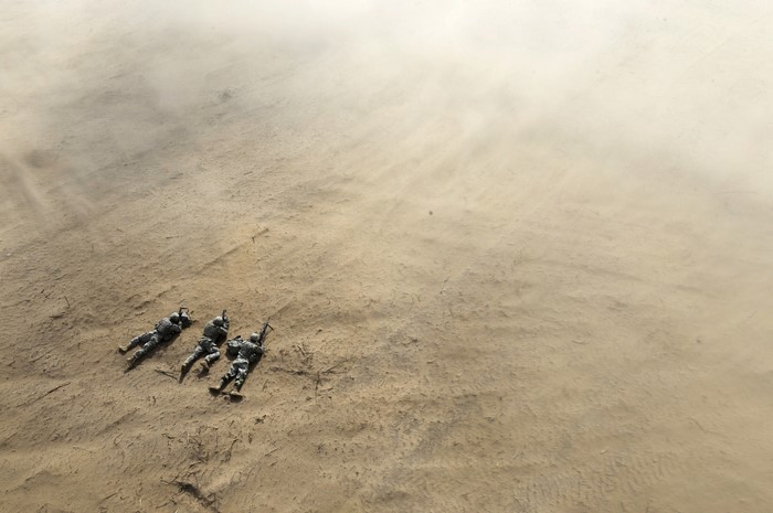 Soldiers lying in the desert sand
