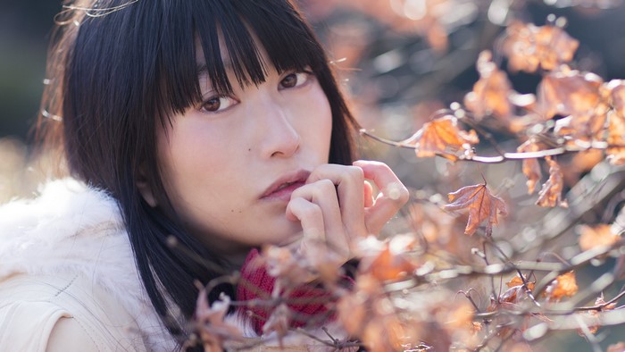 Asian girl with bangs in autumn leaves