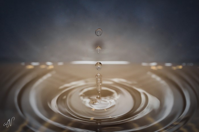 Water drops falling into ripples