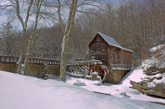 Watermill in a snowy forest landscape