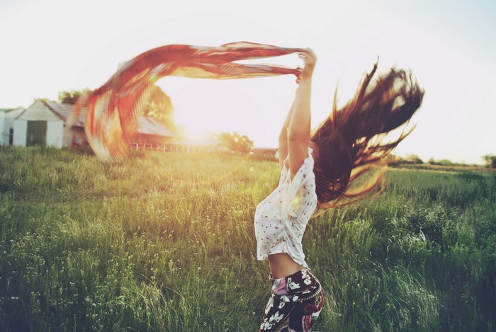 Woman with long hair and scarf in a field