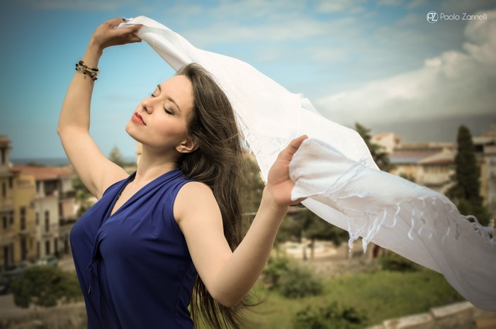Woman with white scarf and blue dress