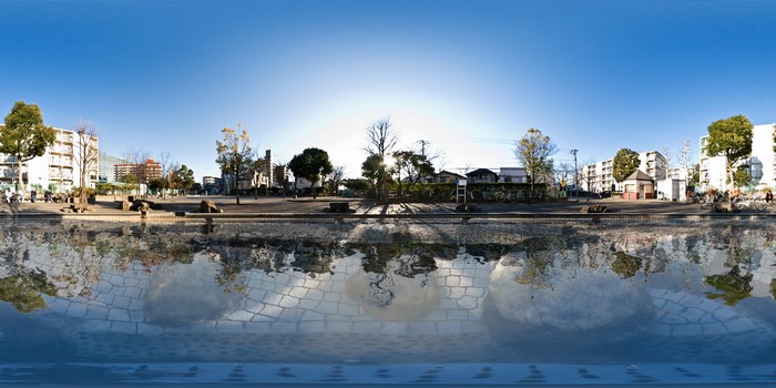 Park with buildings and water reflection in Tokyo