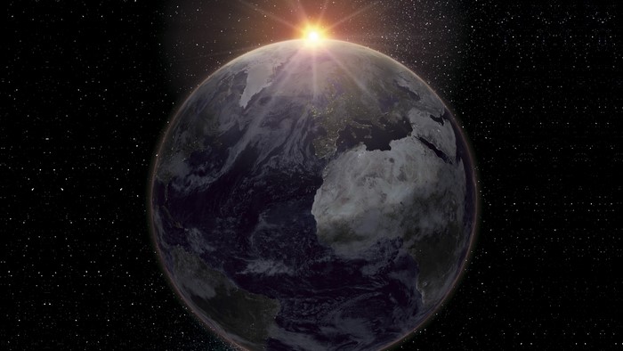 Earth from space with sunrise over Africa and Europe