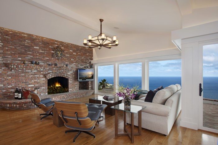 Living room with brick fireplace and ocean view