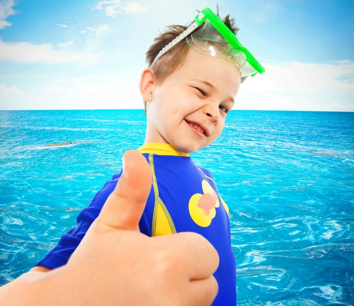 Boy in Swimsuit with Goggles Giving Thumbs Up