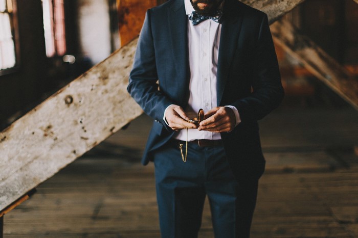 Man in a suit holding a pocket watch