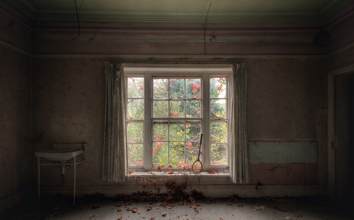 Abandoned room with a window and sink