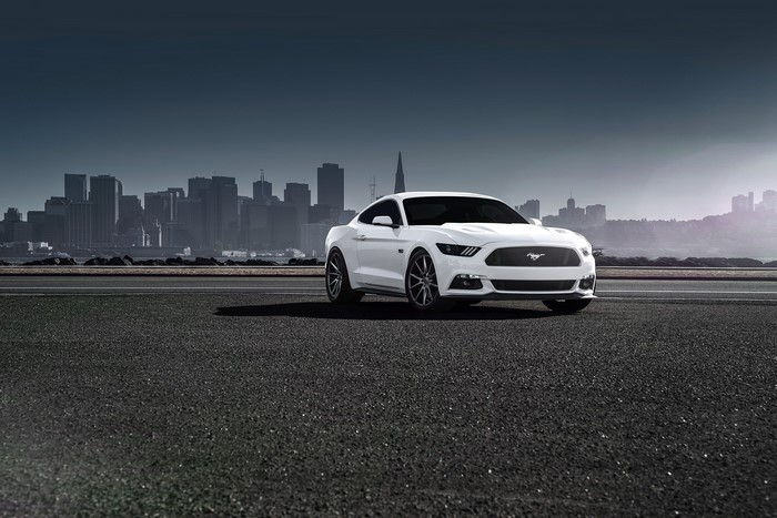 White 2015 Ford Mustang on Asphalt with City Skyline