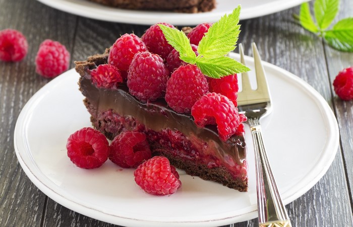 Chocolate raspberry tart slice with fork