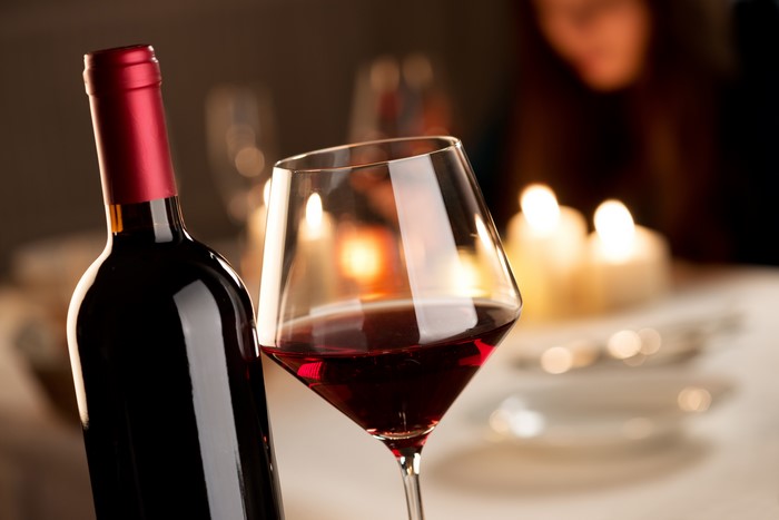 Wine bottle and glass with candles