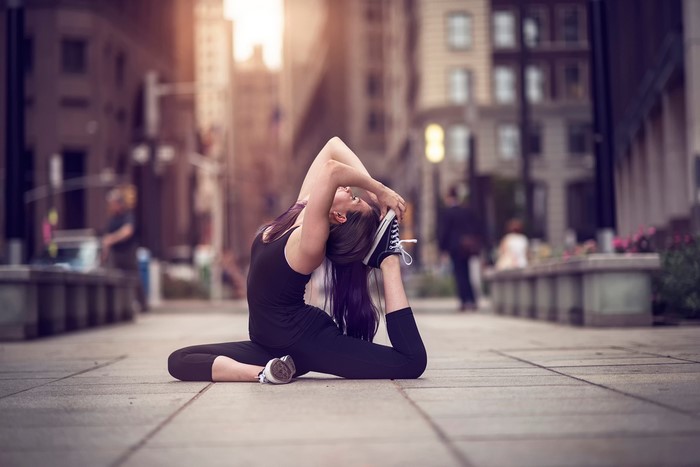 Woman doing yoga in a city street