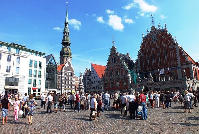 People in Riga Town Square with St. Peter's Church