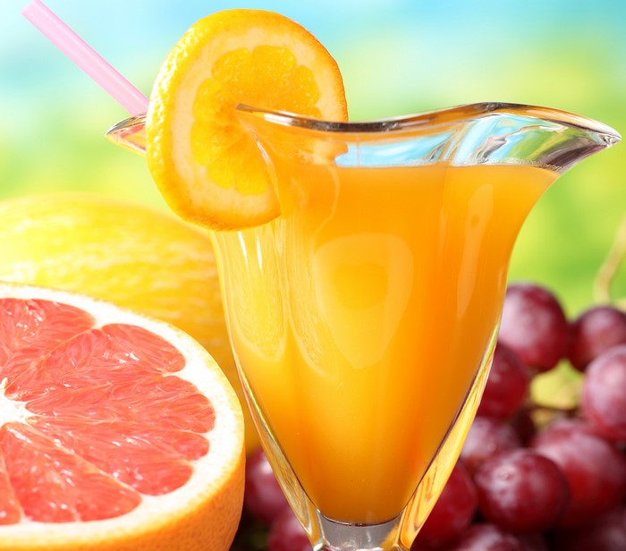 Orange juice with fruits and straw