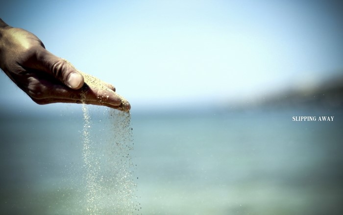 Sand slipping through a hand