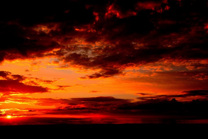 Fiery Sunset Sky with Dark Clouds