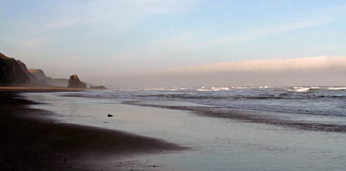 Beach with rocky cliffs and ocean waves