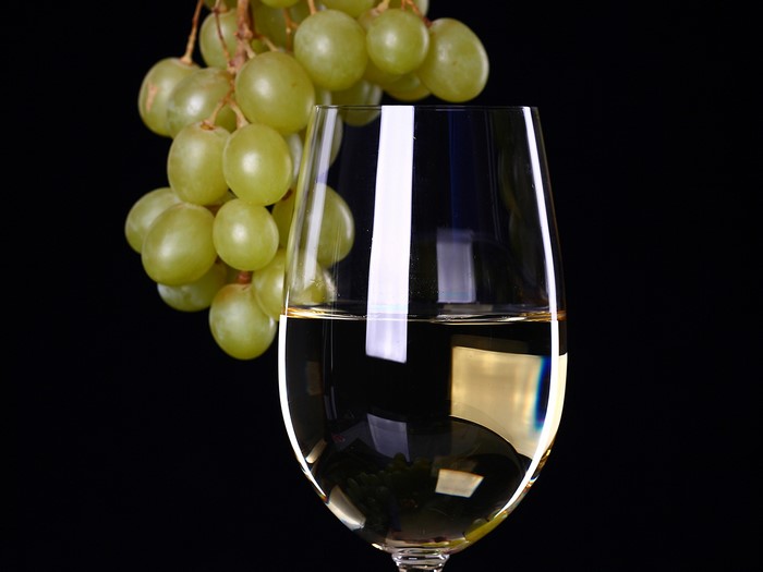 White Wine and Grapes in a Glass