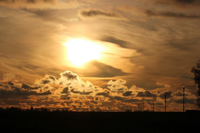 Sunset sky with clouds and power lines