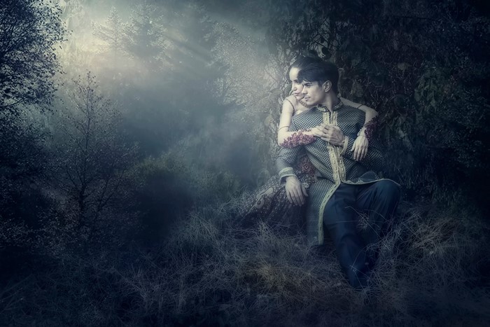 Couple embracing in a misty forest