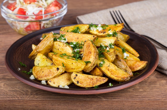 Roasted potato wedges with salad