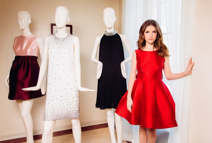 Anna Kendrick in a red dress with mannequins