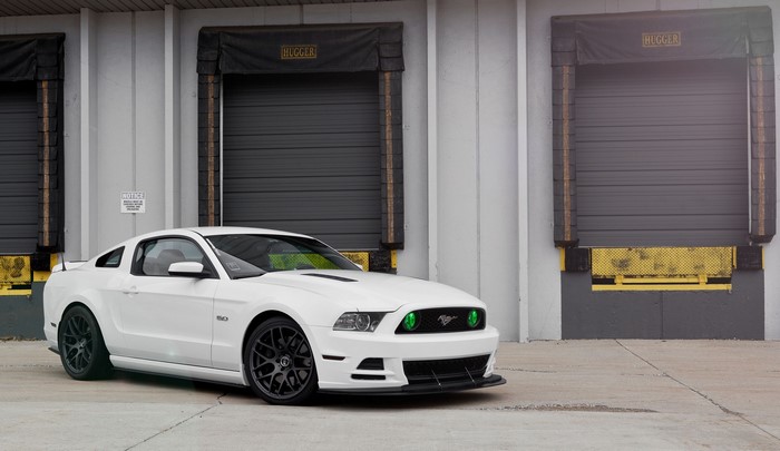 White Ford Mustang GT500 5.0 parked at loading docks