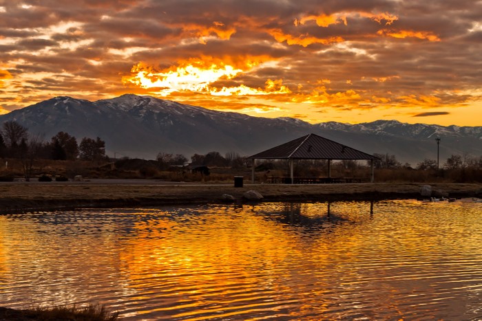 Sunset over mountains and lake in Syracuse, Utah