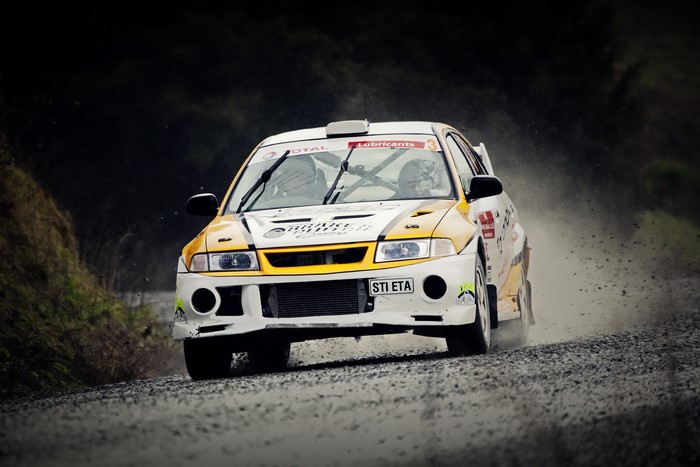 Mitsubishi Lancer WRC rally car on a gravel road