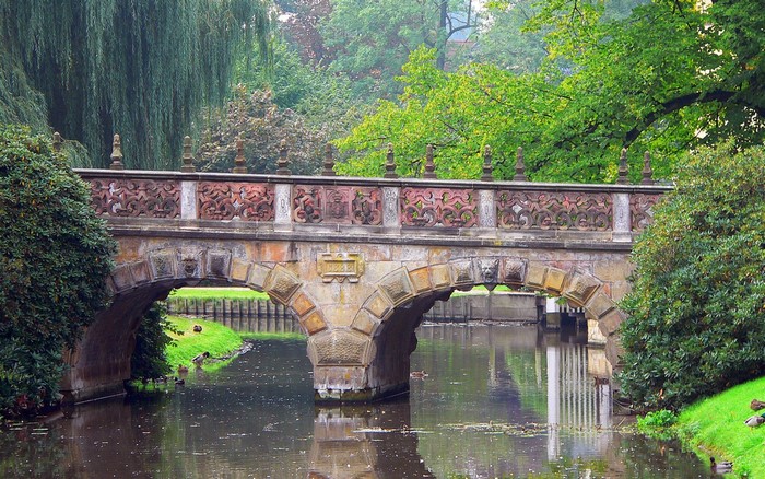 Stone bridge over a canal in a park