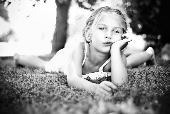 Little girl lying on grass