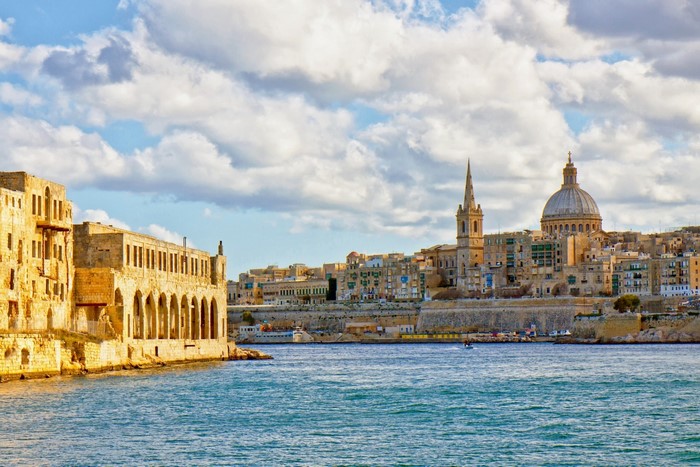 Valletta, Malta cityscape with dome and spire by the sea