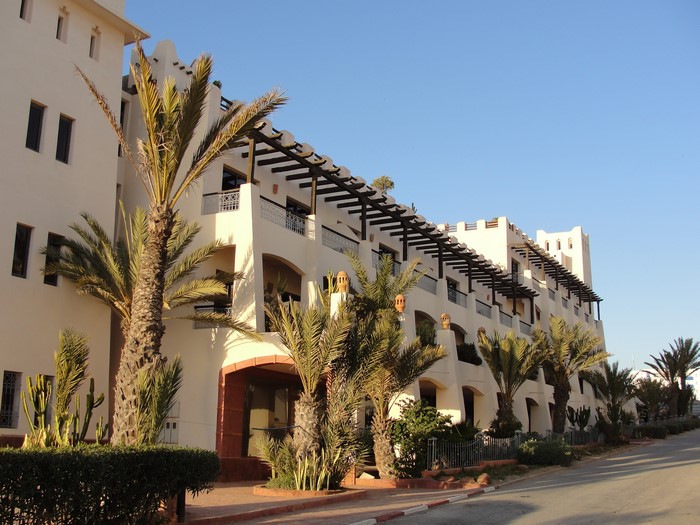 White building with palm trees in Agadir, Morocco