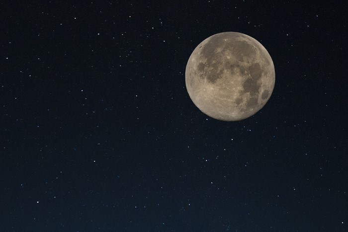 Full moon in a starry night sky
