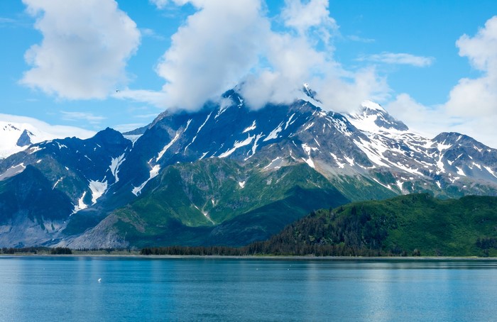 Snow-capped mountains over a lake in Kenai Fjords, Alaska
