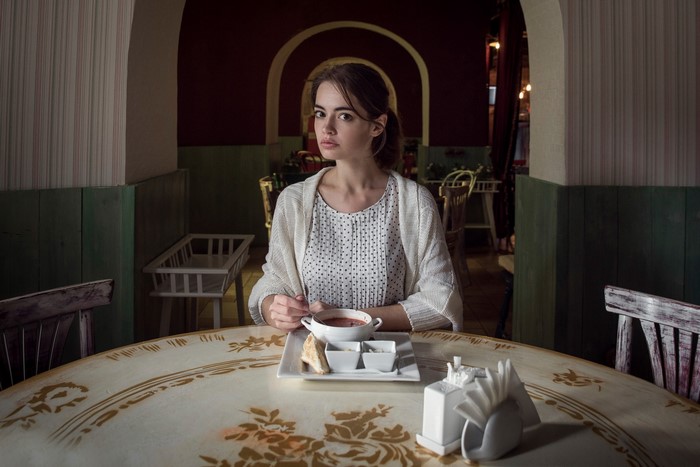Woman sitting at a table with soup