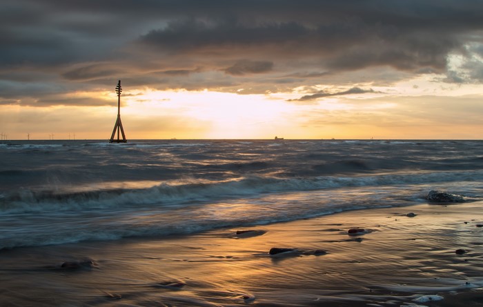 Sunset over the sea with a marker buoy