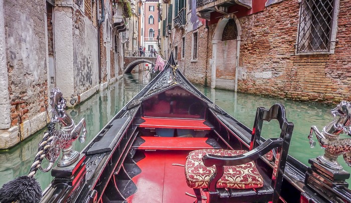 Gondola ride through a Venetian canal in Italy