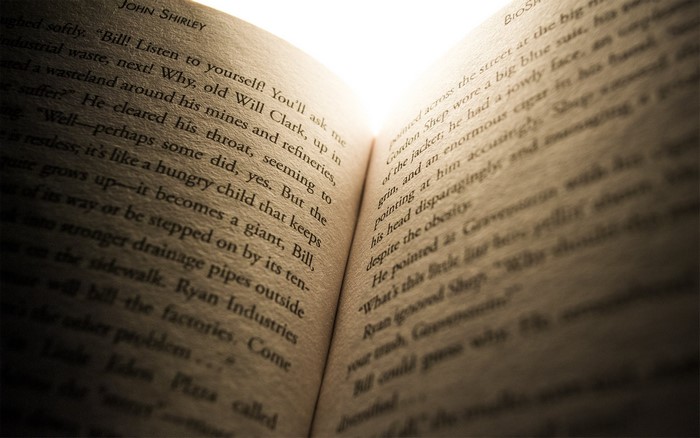 Open book with text by John Shirley