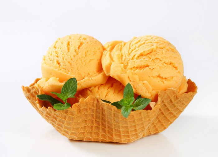 Orange ice cream in a waffle bowl