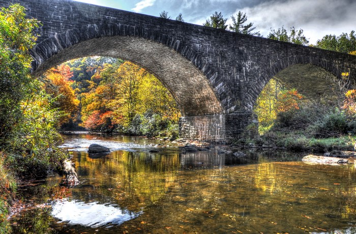 Stone bridge over a river in autumn