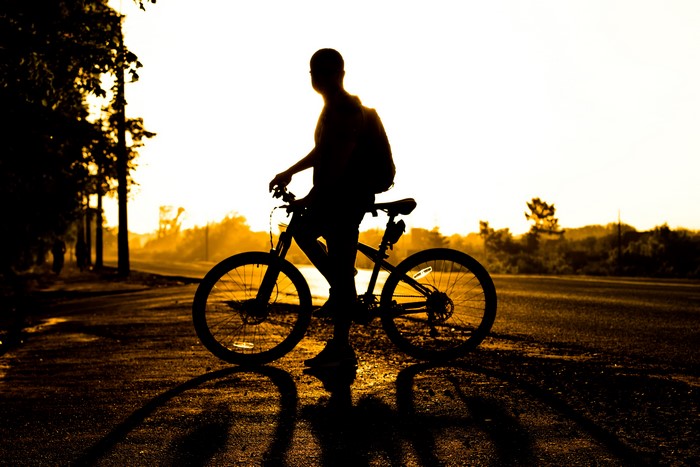 Man with Bicycle Silhouette at Sunset