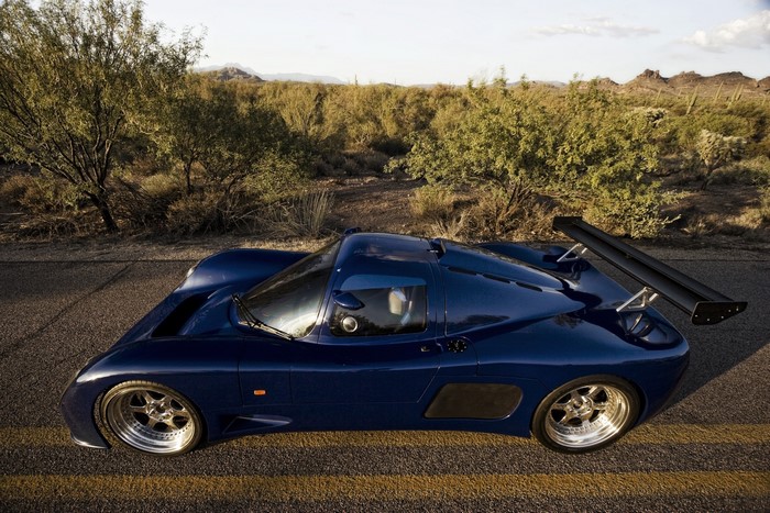 Blue Ultima GTR1 Supercar in desert landscape