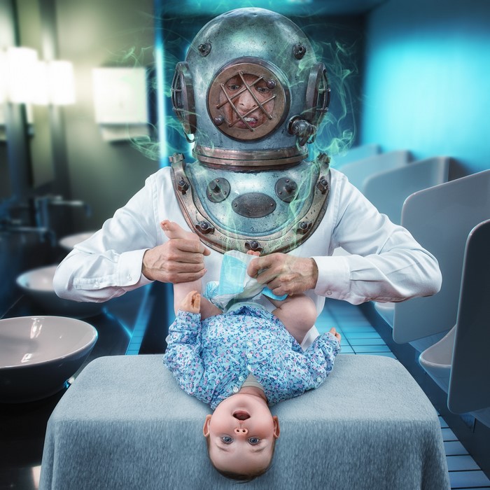 Man in Diving Helmet Changes Baby's Diaper