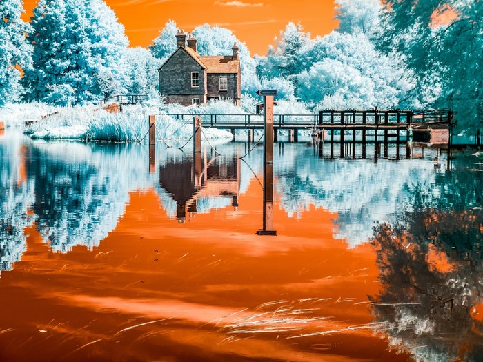 House and bridge over a river with infrared effect