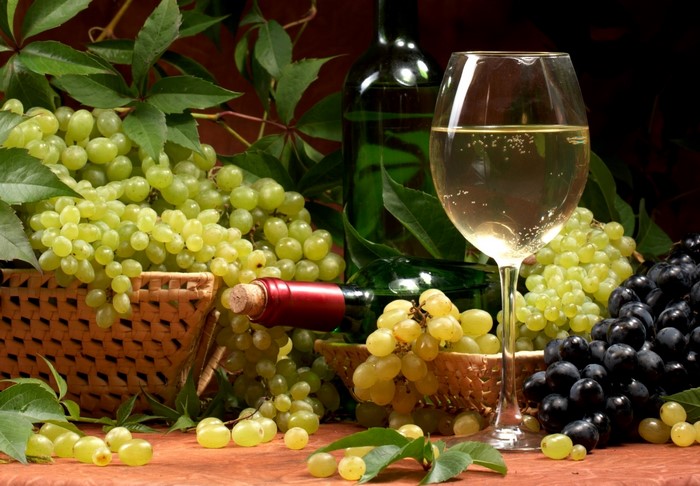 Grapes and wine with stemware and bottles