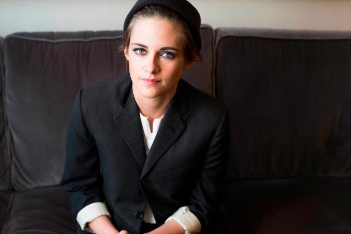 Kristen Stewart wearing a suit and beanie